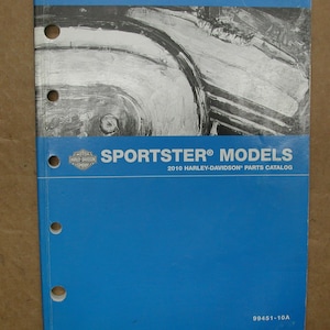 May include: A blue Harley-Davidson parts catalog for Sportster models. The cover features a black and white abstract design and the text "SPORTSTER MODELS 2010 HARLEY-DAVIDSON PARTS CATALOG 99451-10A".
