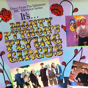 May include: A promotional poster for Monty Python's Flying Circus featuring the show title in gold lettering, a large purple silhouette of a head with glasses, and several photographic scenes from the series. Three VHS tapes are shown at the bottom.