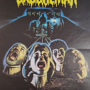 May include: A vintage movie poster for the horror film "Nuits de Cauchemar" featuring a yellow dripping title and four people with ropes around their necks. The poster has a dark blue background with a motel in the distance.