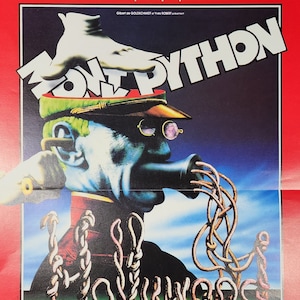 May include: A vintage movie poster for "Monty Python a Hollywood" featuring a surreal illustration. The poster has a red border and includes the words "Monty Python" in large white letters. The illustration depicts a head with a telephone receiver and the word "Hollywood" in a worm-like font.