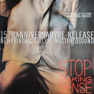 May include: A poster for the 15th anniversary re-release of the film "Stop Making Sense" by Jonathan Demme and Talking Heads. The poster features a close-up of David Byrne in a beige suit, with the film title in red letters.