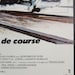 May include: A black and white movie poster for the film "Runaway Train". The poster features the title "de course" in large, bold letters. The text below the title reads "OLAN GLOBUS pour NORTHBROOK FILMS P. RYAN T.K. CARTER et KENNETH MCMILLAN LAN HUME B.S.C. musique composée et dirigée par TREVOR JONES -, PAUL ZINDEL' et EDWARD BUNKER ANDREI KONCHALOVSKY". The poster also includes the logo for UGC and the words "RUNAWAY TRAIN" in smaller letters.
