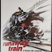 May include: A movie poster for the film "Runaway Train" starring Jon Voight, Eric Roberts, and Rebecca De Mornay. The poster features a black and red train speeding towards the viewer with a man on top of the train.