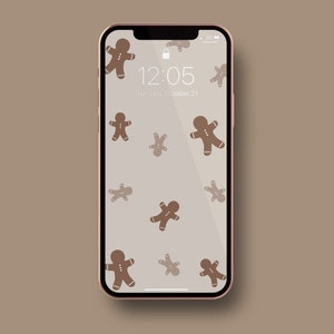 May include: A phone screen with a gingerbread man pattern. The time is 12:05 and the date is Friday, 21st October.