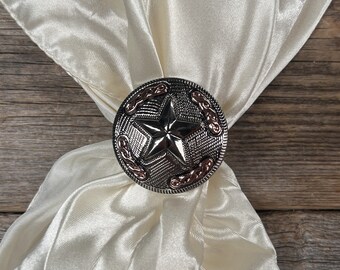 May include: A white satin scarf with a silver and copper star-shaped bolo tie. The bolo tie has a braided design around the edge.