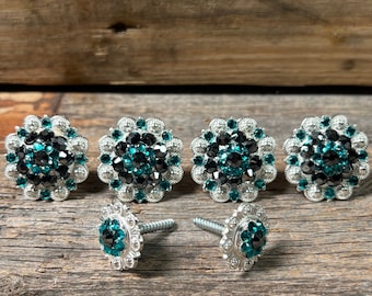 May include: Five silver-toned, round, decorative embellishments with teal rhinestones. Two of the embellishments have a screw on the back.