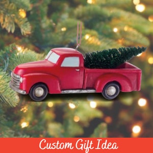 May include: Red vintage pickup truck Christmas ornament with a small green Christmas tree in the bed of the truck.