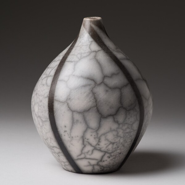 Black and white hand thrown naked raku bottle.