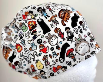 May include: White fabric hat featuring a colorful pattern of cartoon characters. The design includes various figures in different poses, with a variety of colors and shapes. The hat is likely for casual wear.
