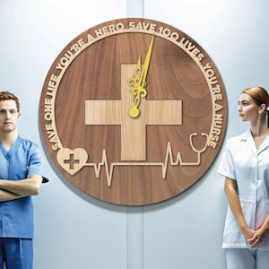 May include: A round wooden wall clock with a light wood cross in the center. The clock has a dark wood background with the text "SAVE ONE LIFE, YOU'RE A HERO, SAVE 100 LIVES, YOU'RE A NURSE" around the edge. The clock hands are gold.