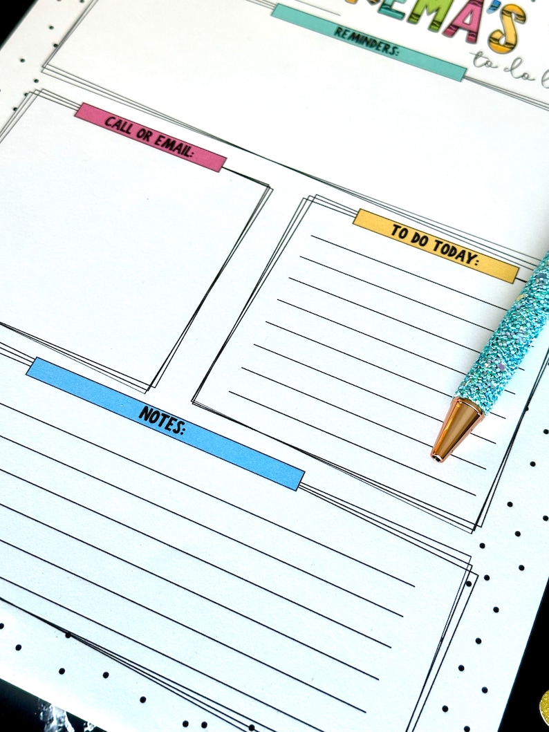 May include: A white planner with black lines and black polka dots. The planner has sections for reminders, to do today, call or email, and notes. The planner has a blue, yellow, and pink colored title.