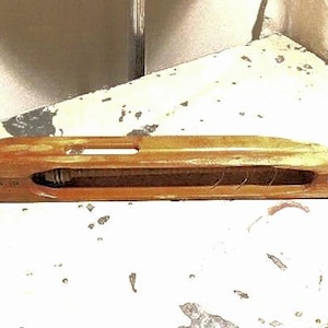 Vintage industrial weaver’s flying shuttle