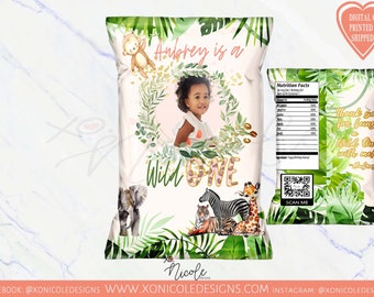 May include: A personalized chip bag design for a first birthday party. The bag features a jungle theme with green leaves, a monkey, a zebra, a giraffe, and an elephant. The text on the bag reads "Audrey is a Wild One".