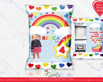 May include: A light blue party favor bag with a rainbow, clouds, and stars design. The bag features the name "Becca" and the number "4". The bag also has a picture of a young girl. The text "Thank you for being a rainbow of fun!" is also on the bag.