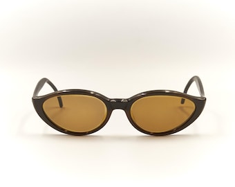 May include: Brown cat-eye sunglasses with brown lenses.