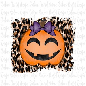 May include: A smiling orange pumpkin with a purple bow on top. The pumpkin is set against a brown and black leopard print background.
