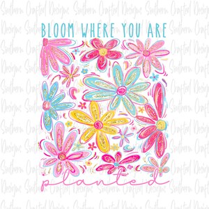May include: A colorful floral design with the words "BLOOM WHERE YOU ARE PLANTED". The flowers are in shades of pink, yellow, and blue with gold glitter accents. The design is on a white background.