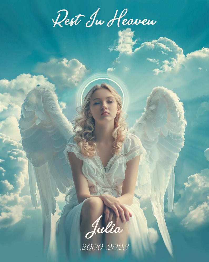 May include: A white angel with wings sits in a blue sky with white clouds. The angel has blonde hair and is wearing a white dress. The text "Rest In Heaven" is at the top of the image and "Julia 2000-2023" is at the bottom.