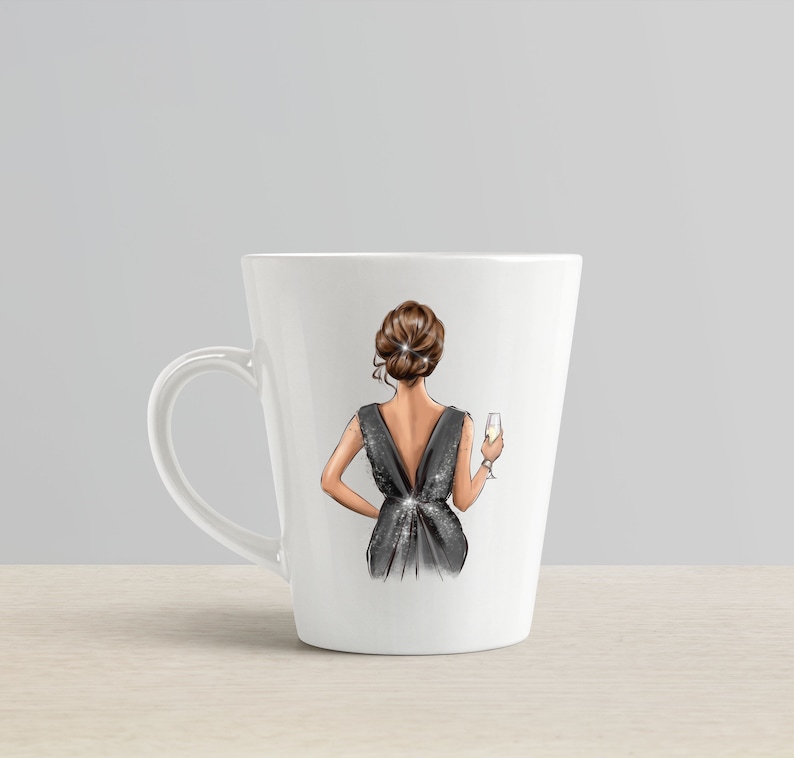 May include: White ceramic mug with a black and silver illustration of a person in a dress holding a glass of champagne.