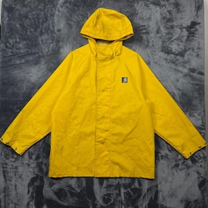 May include: A bright yellow hooded rain jacket featuring long sleeves with snap button cuffs, a front zip closure concealed by a placket, and a small square black logo patch on the left chest area. The jacket is constructed with a hood.