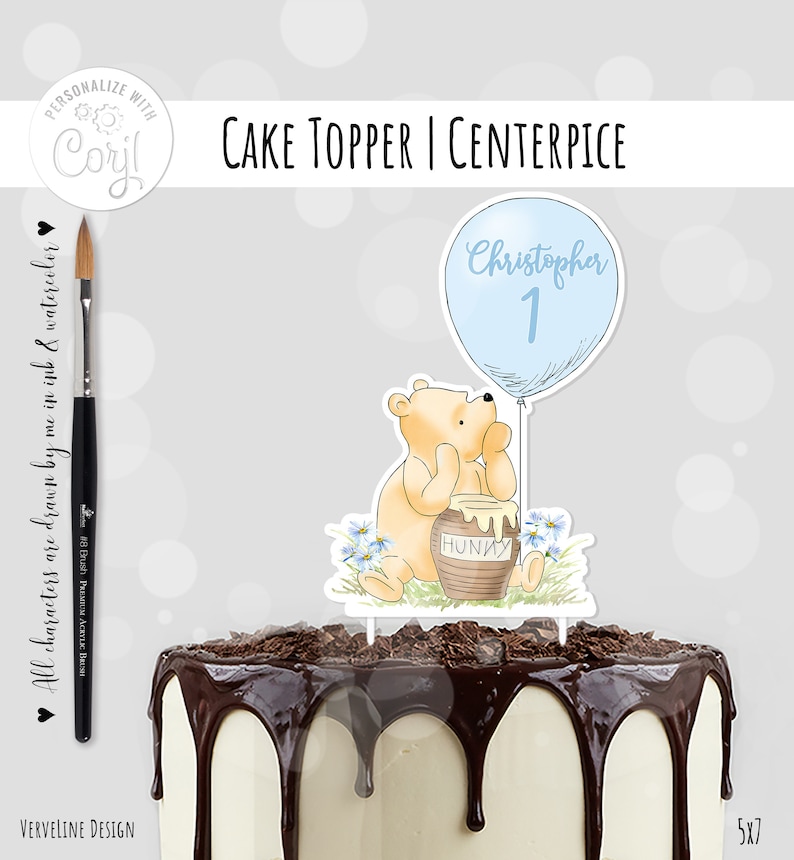 May include: A Winnie the Pooh cake topper with a blue balloon that says "Christopher 1" and a honey pot. The topper is on a chocolate cake with white frosting.