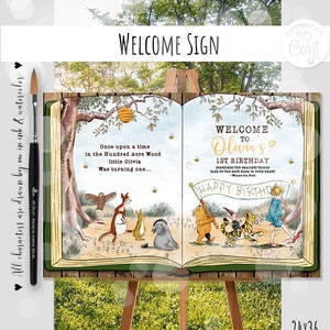 K&ouml;nnte beinhalten: Ein Willkommens-Schild zum 1. Geburtstag im Winnie Puuh-Stil. Das Schild zeigt ein Buch mit Illustrationen von Winnie Puuh und seinen Freunden. Der Text auf dem Schild lautet: "Willkommen zu Olivias 1. Geburtstag. Manchmal nehmen die kleinsten Dinge den meisten Platz in deinem Herzen ein - Winnie Puuh. Alles Gute zum Geburtstag".