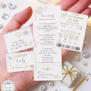 May include: A hand holds a collection of Tooth Fairy items. Included are a letter, a certificate, a receipt, and a small gift box tied with gold ribbon. The items are decorated with stars, butterflies, and fairy dust.