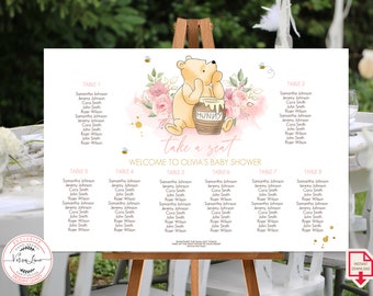 Puede incluir: Un plano de asientos para una baby shower con temática de Winnie the Pooh con un fondo de acuarela de flores rosas y purpurina dorada. El gráfico enumera las mesas del 1 al 8 con los nombres de los invitados en cada mesa. El texto "Take a seat" y "Welcome to Olivia's Baby Shower" está escrito en una fuente caprichosa.
