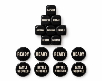 May include: A collection of eight black square dice and eight black circular tokens. The dice feature white text including KAPTARIS, CALISTUS, RENDAX, CONSERVAI, DACATARAI, and SALVUS. The circular tokens feature the white text READY and BATTLE SHOCKED.