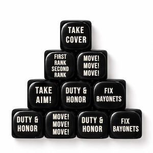 May include: A pyramid arrangement of ten black square dice with rounded corners. Each die features white printed text including phrases such as TAKE COVER, FIRST RANK SECOND RANK, MOVE! MOVE! MOVE!, TAKE AIM!, DUTY & HONOR, and FIX BAYONETS.