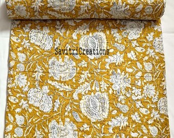 May include: A yellow and white floral kantha quilt with a hand-stitched design. The quilt is made of cotton and is perfect for adding a touch of bohemian style to your home.