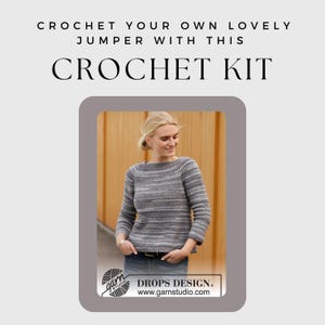 May include: A crochet kit with the text "CROCHET KIT" at the top. The image shows a woman wearing a gray and white striped crochet sweater. The sweater has a round neckline and long sleeves. The kit is from Drops Design.