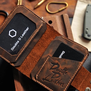 May include: A brown leather wallet with two card slots and the text "Double D Leather" embossed on the front.