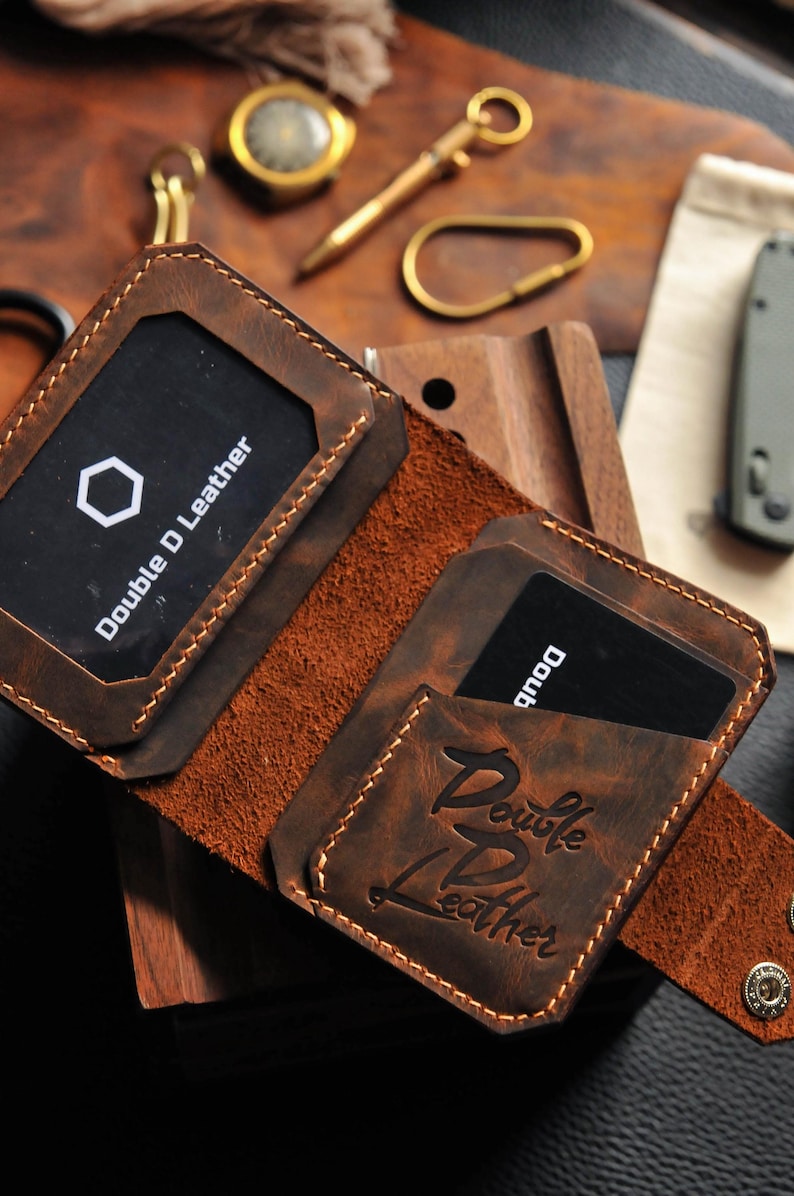 May include: A brown leather wallet with two card slots and the text "Double D Leather" embossed on the front.