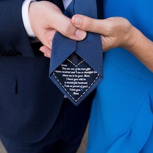May include: A blue tie with a white heart-shaped tag that says "Drew, You are one of the best gifts I have received and I am so thankful you chose me to be your Mom. I know you will be a wonderful husband. I am so proud of you! I love you Mom."
