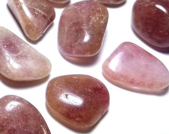 May include: A collection of tumbled pink and brown stones. The stones are smooth and polished, with a variety of shapes and sizes.