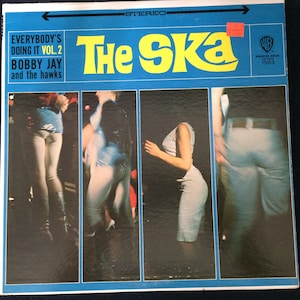 May include: Vintage vinyl record album cover for "Everybody's Doing It Vol. 2" by Bobby Jay and the Hawks. The album cover is blue with yellow text that reads "The Ska." The cover features images of people dancing.