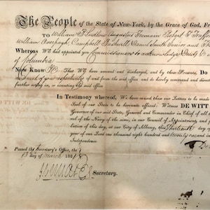 May include: An antique document from the State of New York, with elaborate handwriting and signatures. The document, possibly a legal or official record, is on aged paper with signs of wear, and includes the text "The People of the State of New-York."