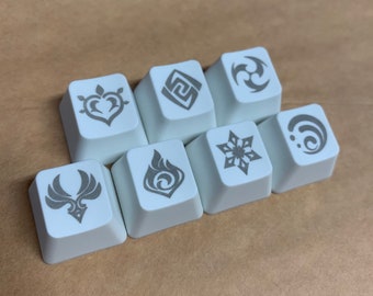 May include: Seven white keycaps with different gray symbols printed on them. The symbols include a heart, a square, a snowflake, a flame, a bird, a circle with dots, and a three-pointed star.