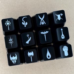 May include: A set of 12 black keycaps with white symbols. The symbols are various fantasy-themed icons, such as a sword, a lute, a hand with a magic wand, and a dragon.