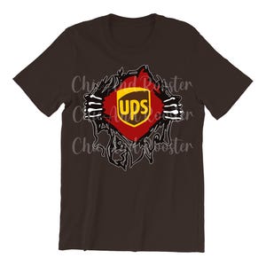 May include: A dark brown t-shirt with a graphic design showing a ripped effect, revealing the UPS logo. The logo is in a red and gold shield shape, with the word "ups" in white.