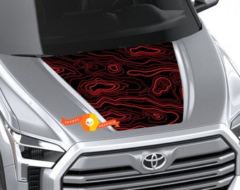 May include: A silver truck with a black bonnet featuring a red topographic map design. The bonnet graphic covers the entire bonnet of the vehicle. The logo "SUPDEC GRAPHIX" is visible on the lower left corner of the bonnet.