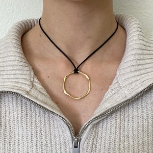 Adjustable black cord necklace with gold wavy hammered open round circle pendant