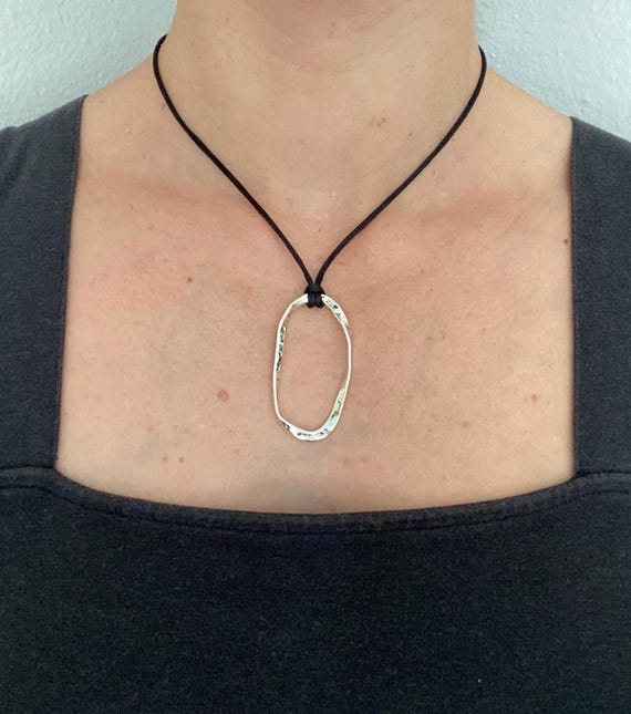 Adjustable black cord necklace with silver wavy hammered open oval pendant