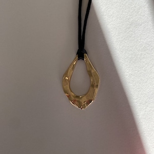 Adjustable black cord necklace with gold wavy hammered open oval water drop pendant image 3