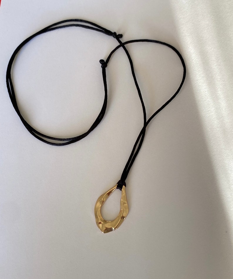 Adjustable black cord necklace with gold wavy hammered open oval water drop pendant image 4