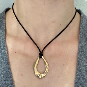 Adjustable black cord necklace with gold wavy hammered open oval water drop pendant image 1