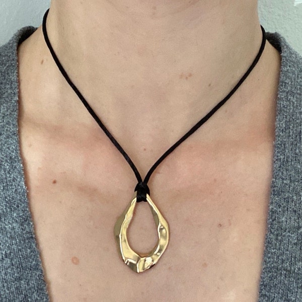 Adjustable black cord necklace with gold wavy hammered open oval water drop pendant