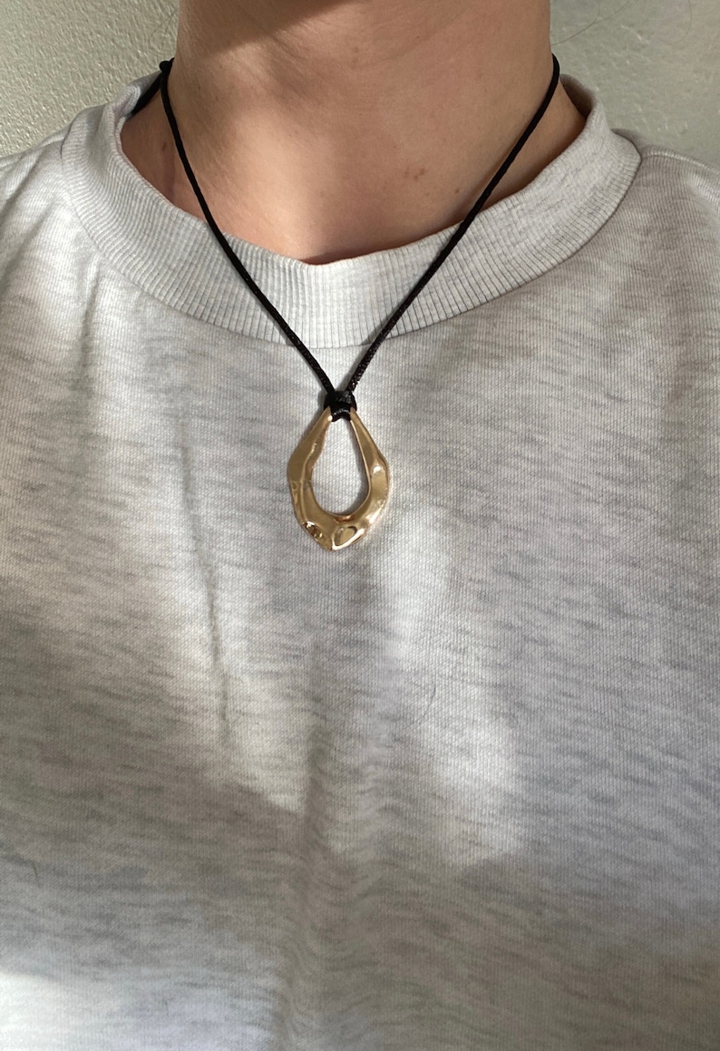 Adjustable black cord necklace with gold wavy hammered open oval water drop pendant image 2