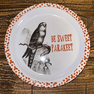 May include: White metal tray with a black and white illustration of a parakeet perched on a branch. The tray has a dotted orange border and the text "BE SWEET PARAKEET" in orange.